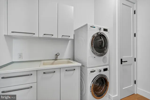 a utility room with sink dryer and washer