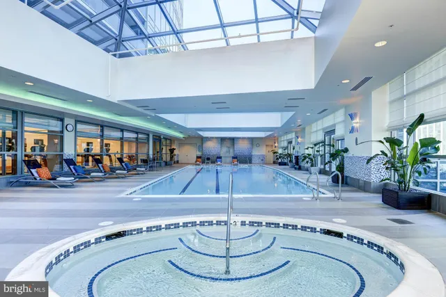 a room with lots of furniture and potted plants