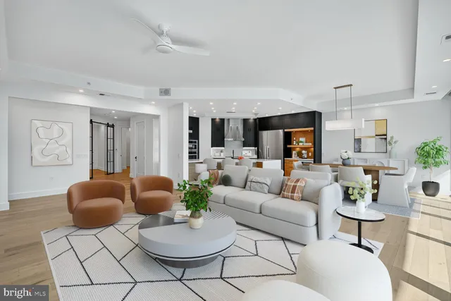 a living room with furniture and kitchen view