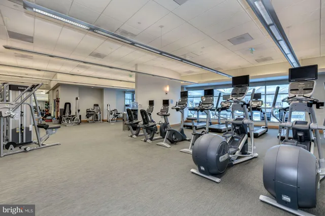a room with gym equipment and a large window