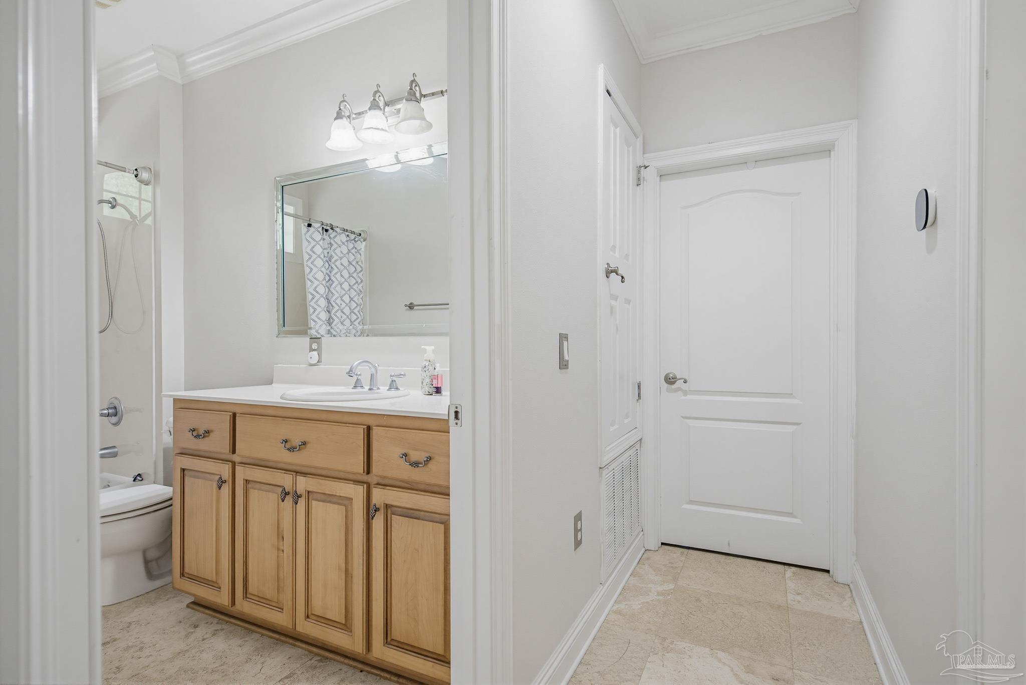 2855 Walling Road Milton, FL 32570 - Photo 44 of 55 a spacious bathroom with a double vanity sink a toilet and a mirror