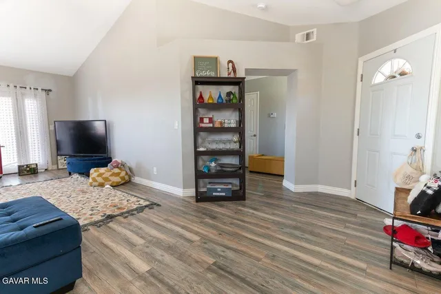 a bedroom with furniture and a flat screen tv