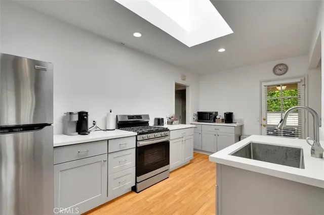 a kitchen with a sink cabinets and stainless steel appliances