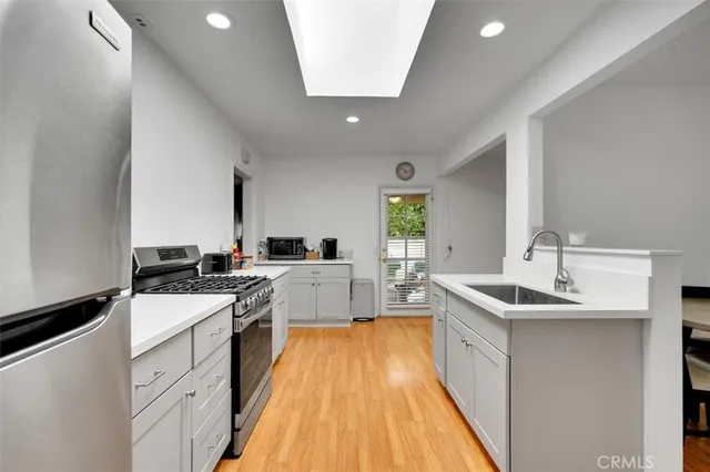 a kitchen with a sink a counter top space and appliances