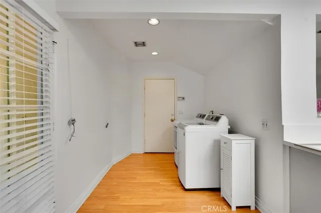 a view of a room with wooden floor and white walls