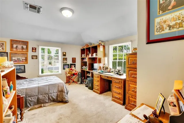 a bedroom with furniture and a large window