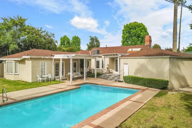 a view of a house with pool yard and a patio