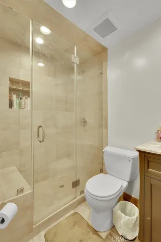 a bathroom with a toilet and shower