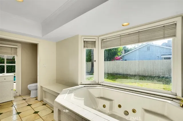 a bathroom with a granite countertop sink and a bathtub