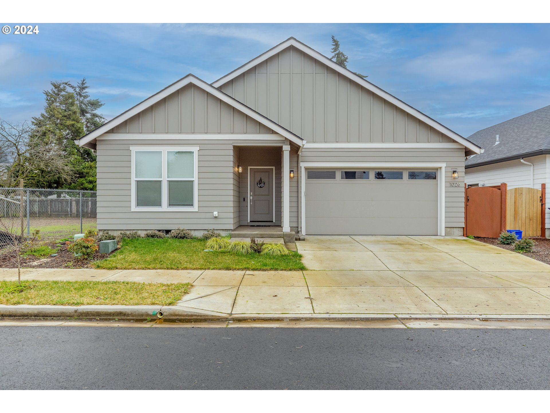 1026 West Olympic Street Springfield, OR 97477 - Photo 1 of 31 a view of a white house with a outdoor space