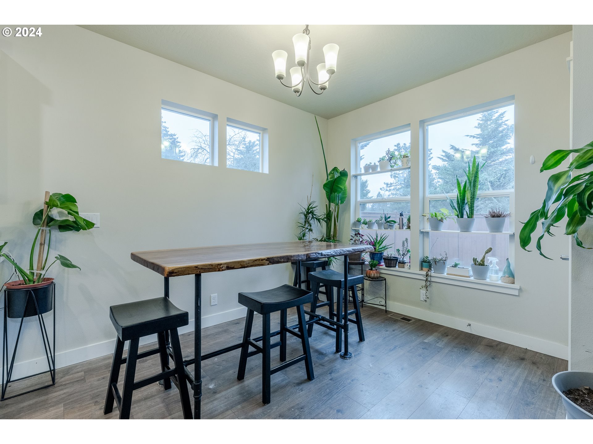 1026 West Olympic Street Springfield, OR 97477 - Photo 12 of 31 a view of a dining room with furniture window and wooden floor