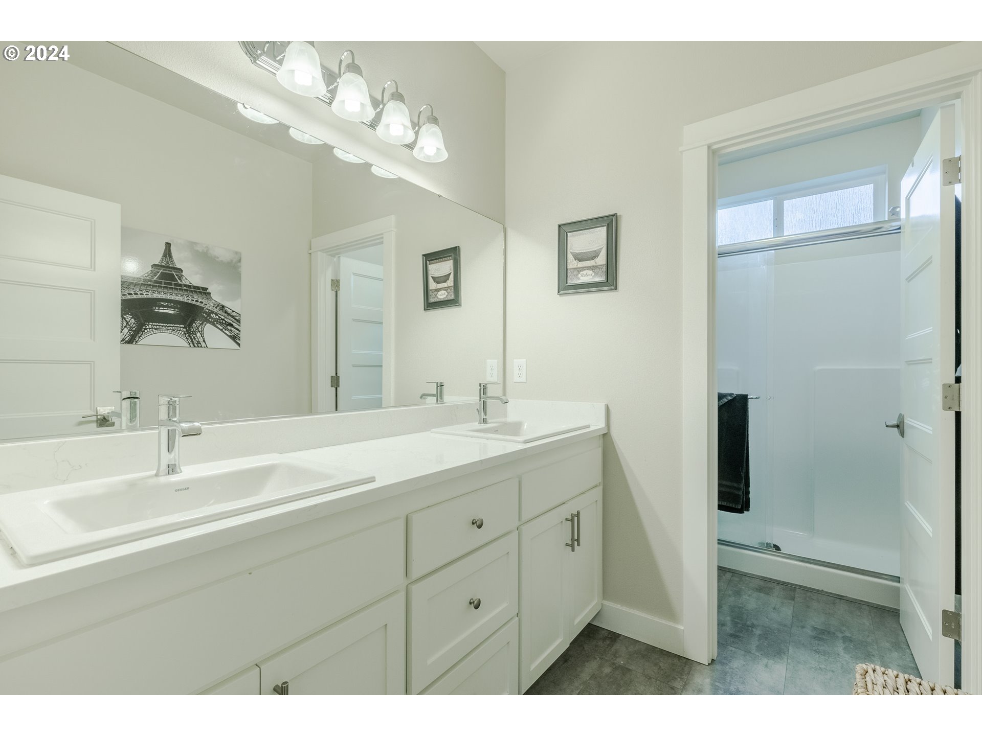 1026 West Olympic Street Springfield, OR 97477 - Photo 20 of 31 a bathroom with a double vanity sink a mirror and shower