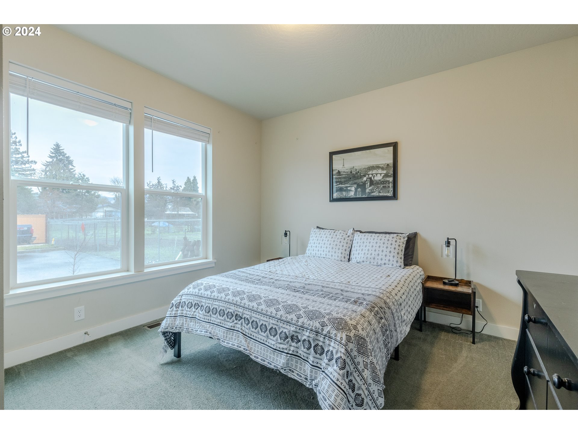1026 West Olympic Street Springfield, OR 97477 - Photo 23 of 31 a bedroom with a bed painting on wall and a large window