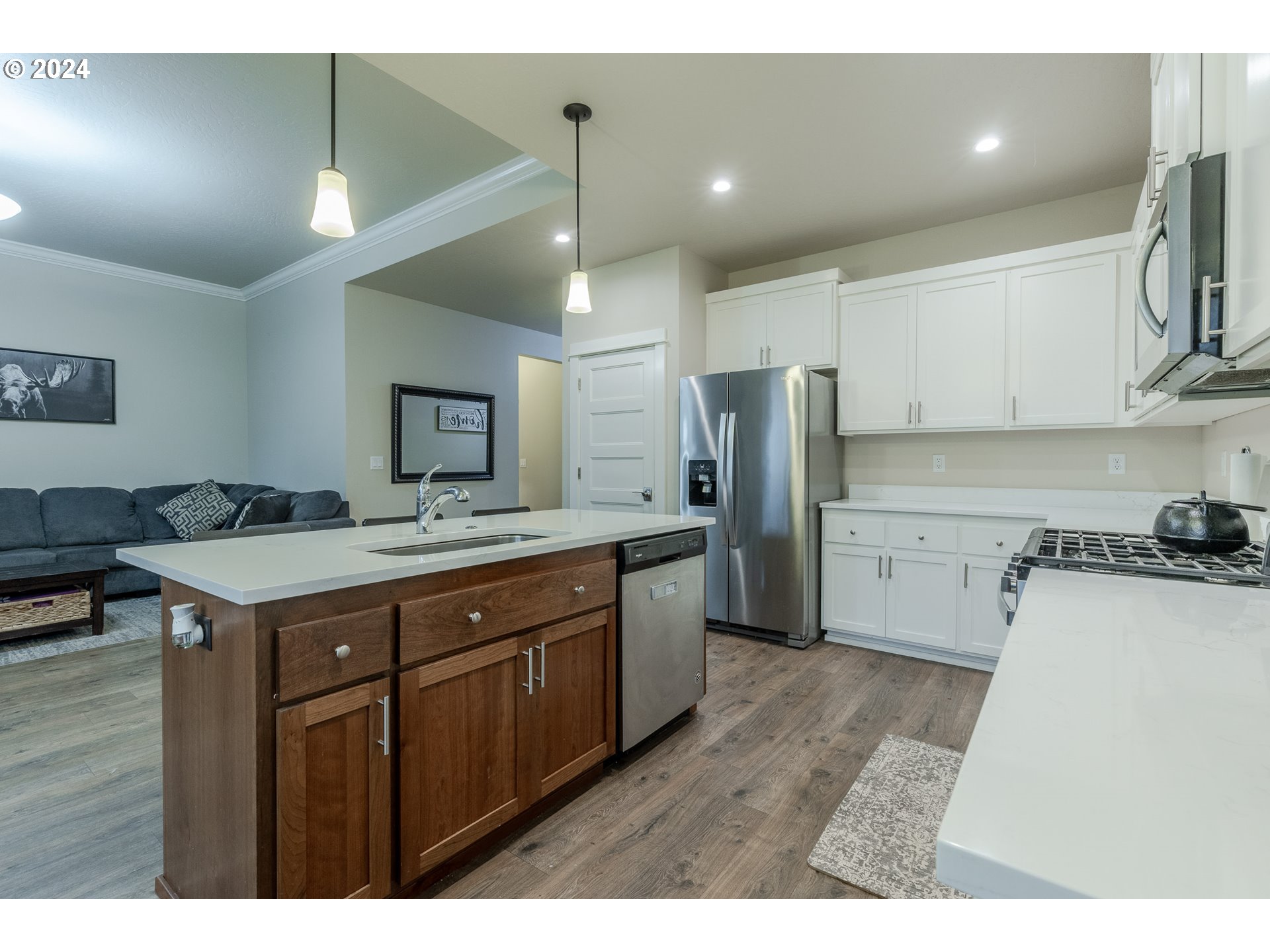 1026 West Olympic Street Springfield, OR 97477 - Photo 9 of 31 a kitchen with a sink stainless steel appliances and cabinets