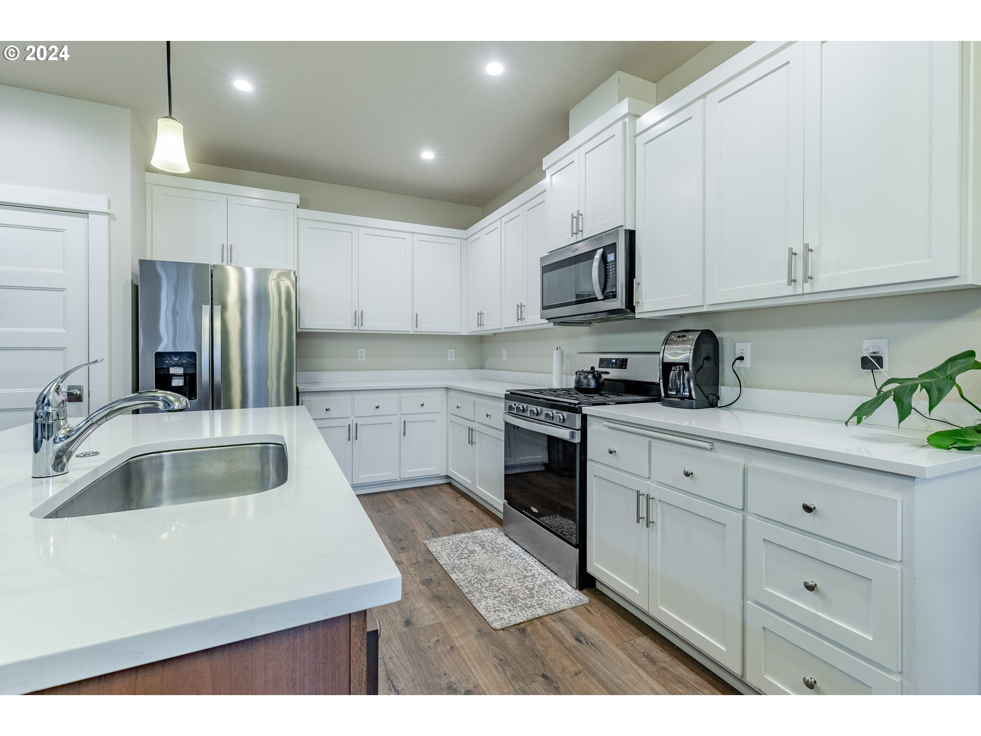 1026 West Olympic Street Springfield, OR 97477 - Photo 10 of 31 a kitchen with cabinets appliances a sink and a counter top space