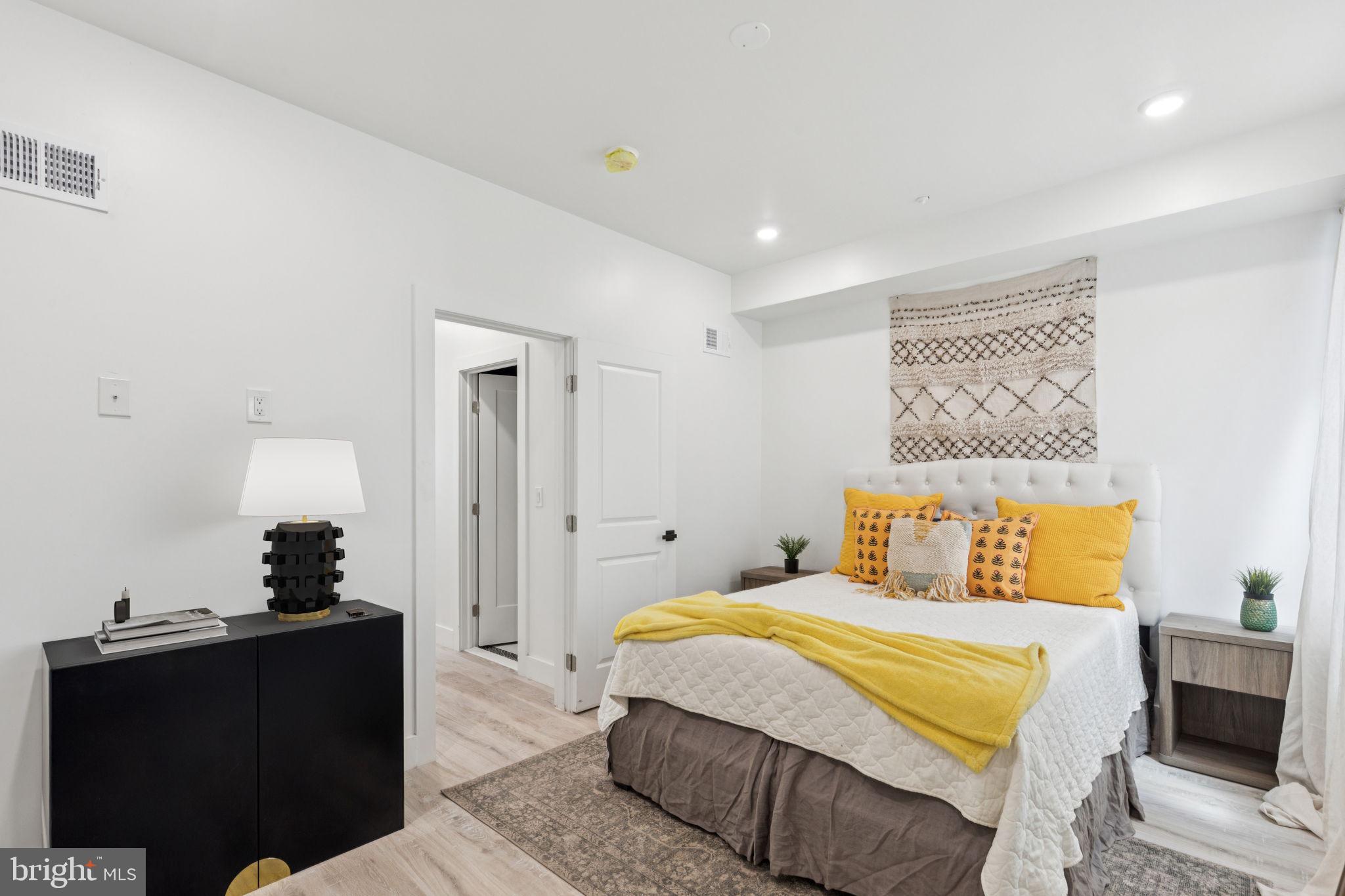 1602 Ridge Avenue, Unit 3 Philadelphia, PA 19130 - Photo 13 of 17 a bedroom with a bed and wooden floor