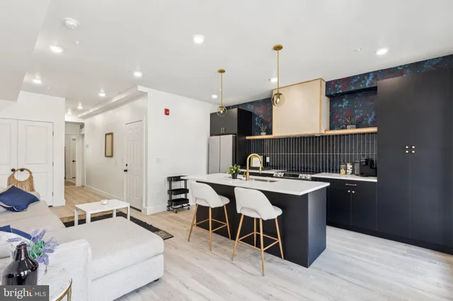 a living room with furniture a wooden floor and chandelier