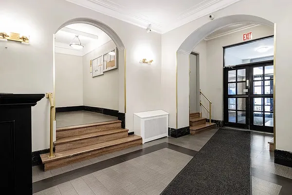 a view of a hallway with windows and stairs