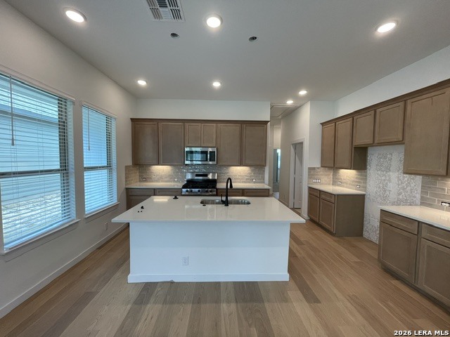 9431 Hidden Stone Schertz, TX 78154 - Photo 8 of 30 a large kitchen with stainless steel appliances a large counter top a stove and a sink