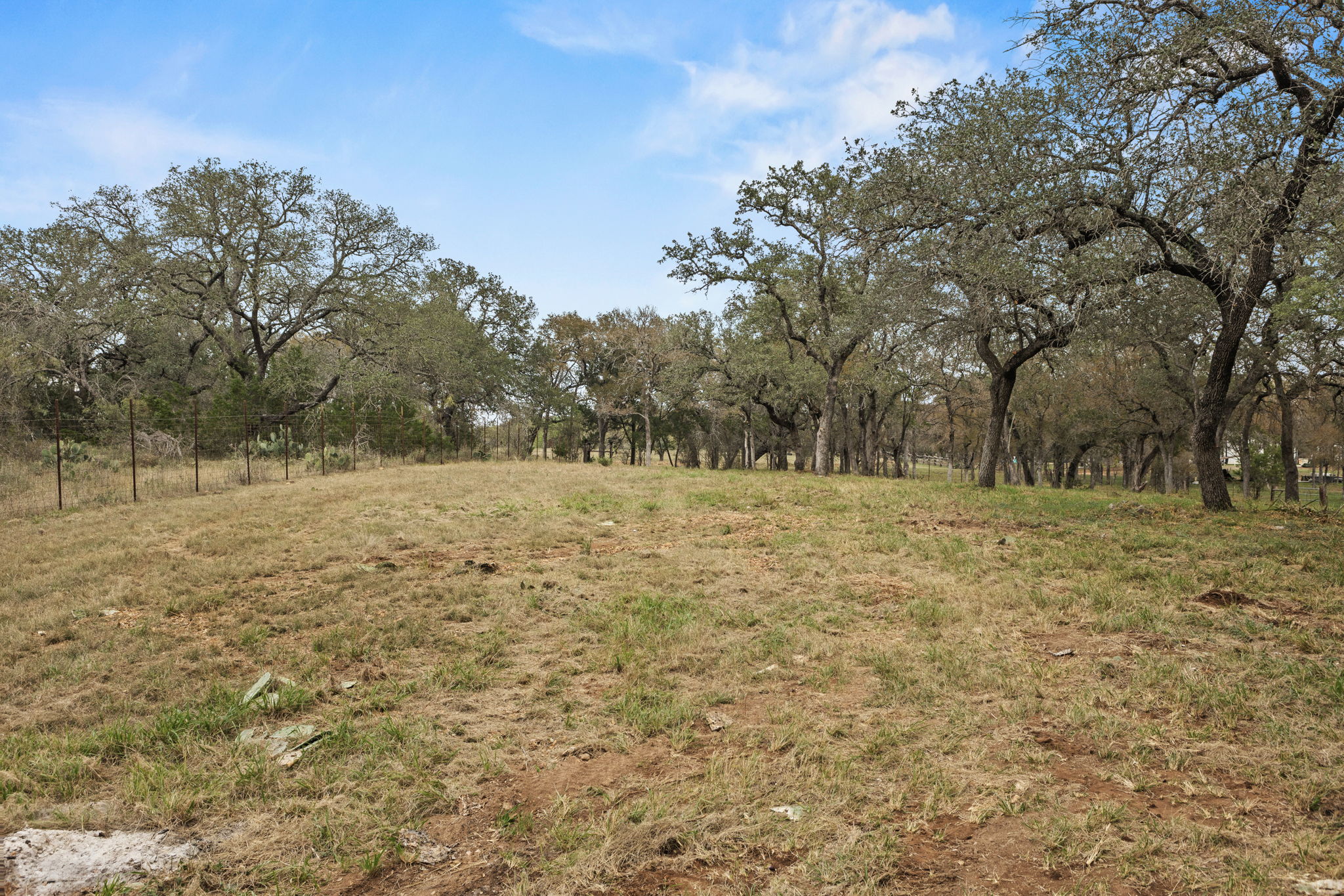 122 Winding Creek Road Spicewood, TX 78669 - Photo 11 of 19 a backyard of a house with large trees