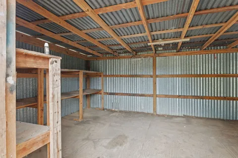 a view of an empty room with wooden walls