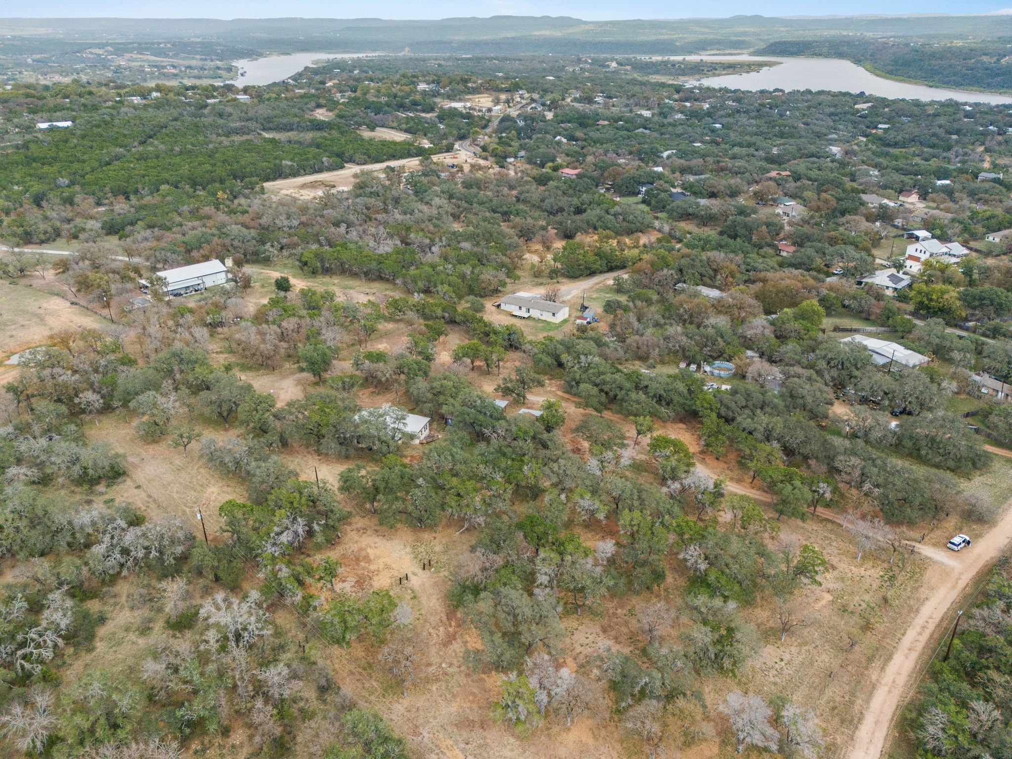 122 Winding Creek Road Spicewood, TX 78669 - Photo 17 of 19 an aerial view of residential houses with outdoor space and trees