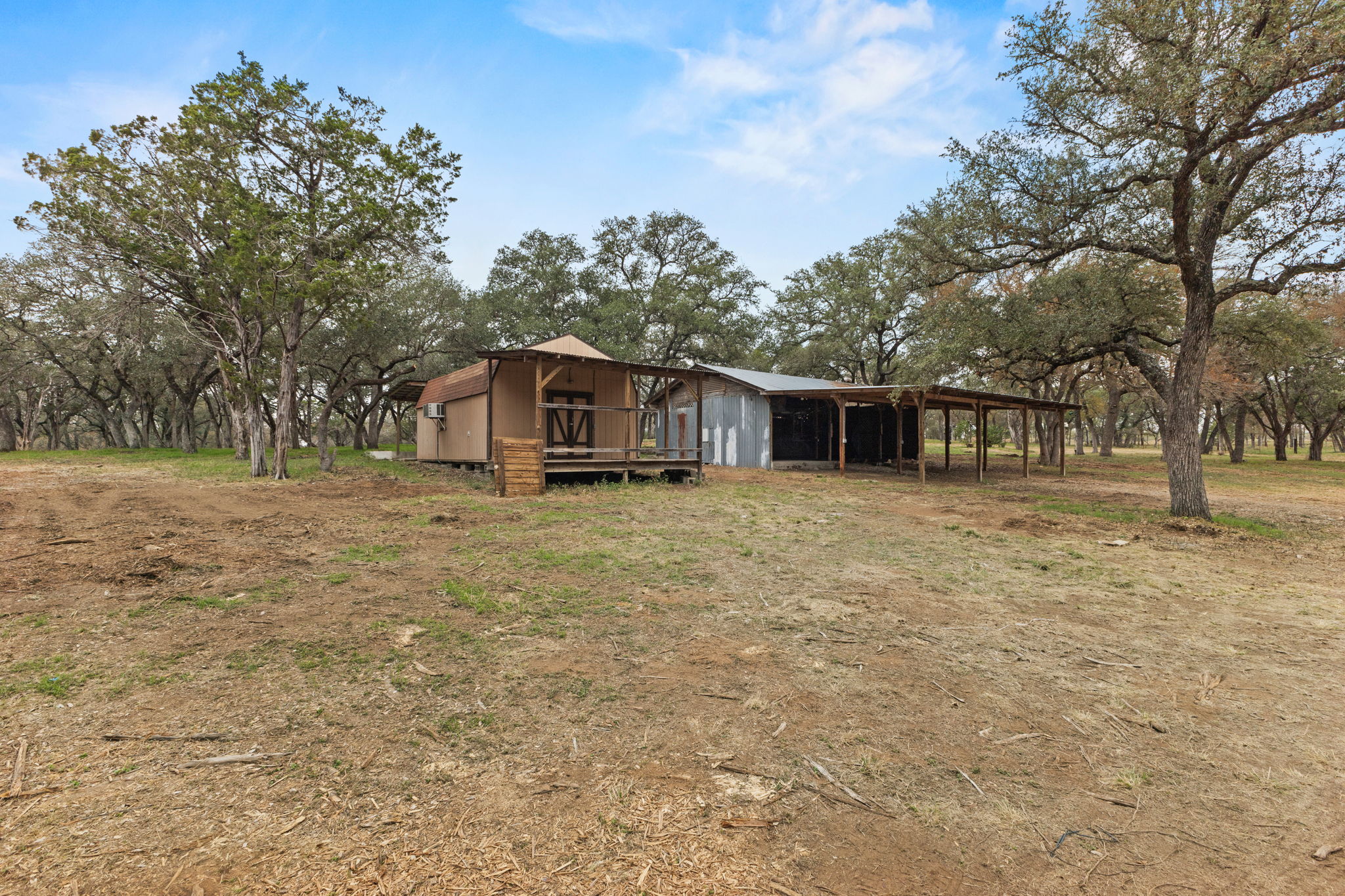 122 Winding Creek Road Spicewood, TX 78669 - Photo 3 of 19 a house with trees in front of it