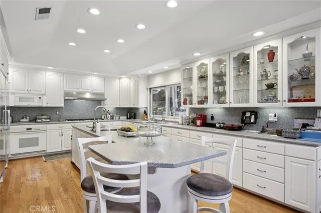 a bedroom with a bed and a large window with chair