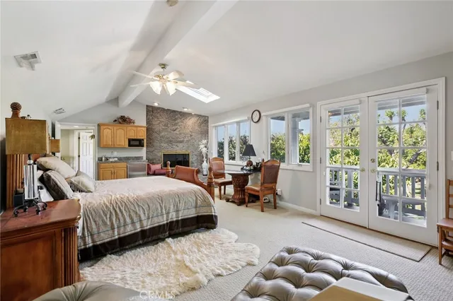 a living room with furniture a large window and a chandelier