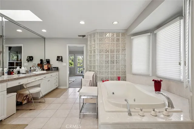 a kitchen with cabinets wooden floor and stainless steel appliances