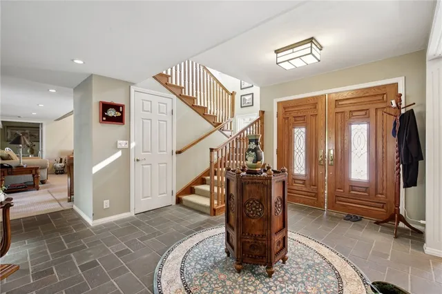a living room with furniture fireplace and a large window