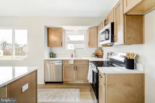 a kitchen with a sink stove and cabinets