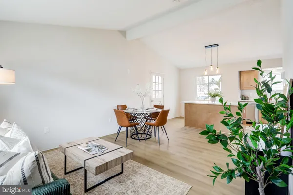 a dining room with furniture and wooden floor