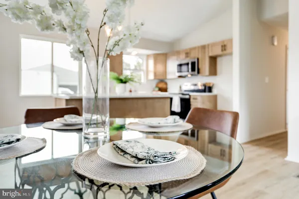 a dining room with furniture a window and wooden floor