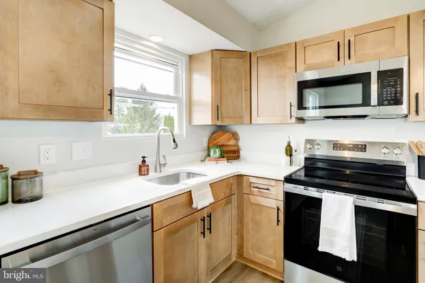 a kitchen with a sink stove and microwave