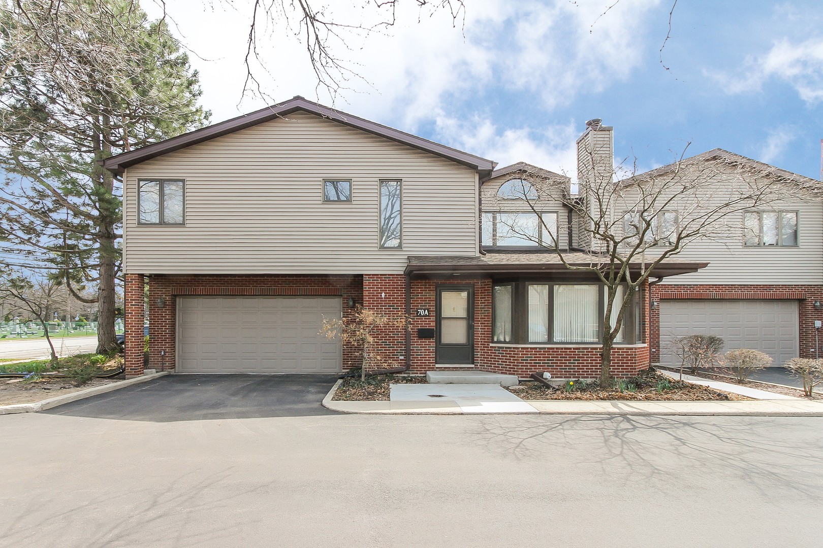 70 South Dee Road, Unit A Park Ridge, IL 60068 - Photo 1 of 20 a front view of a house with a yard and garage