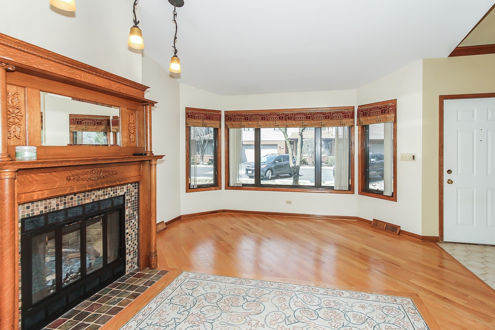70 South Dee Road, Unit A Park Ridge, IL 60068 - Photo 3 of 20 a view of an empty room with wooden floor fireplace and a window