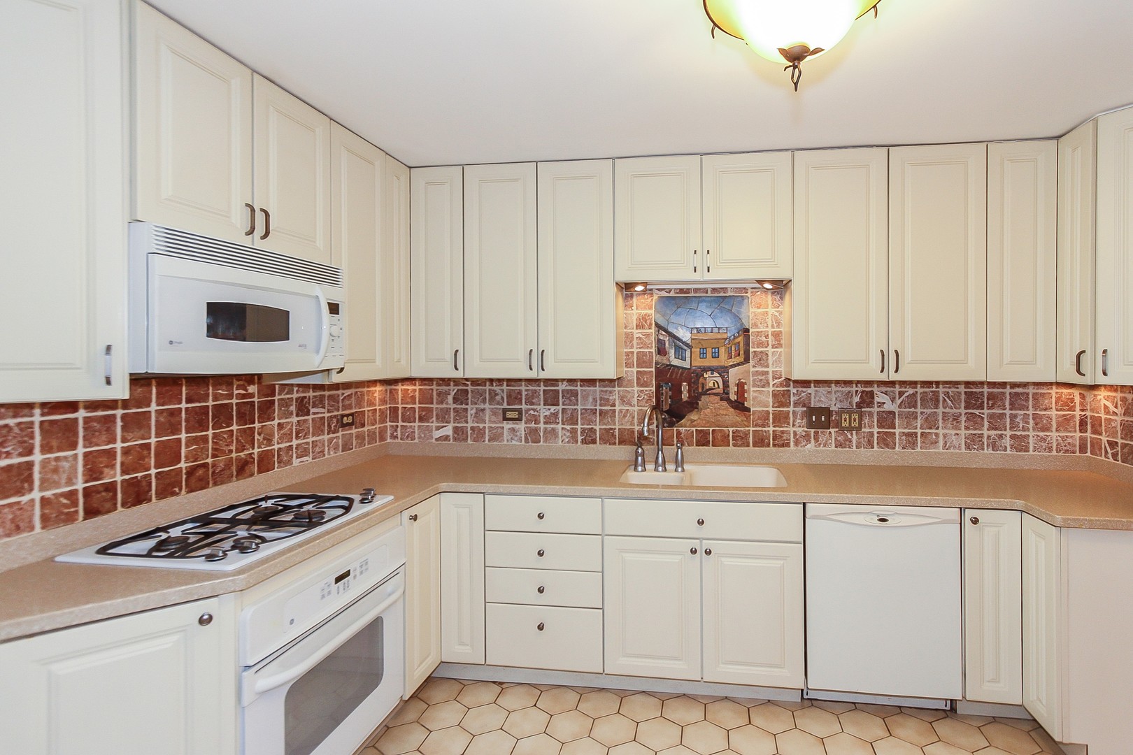 70 South Dee Road, Unit A Park Ridge, IL 60068 - Photo 7 of 20 a kitchen with granite countertop a sink a stove and cabinets