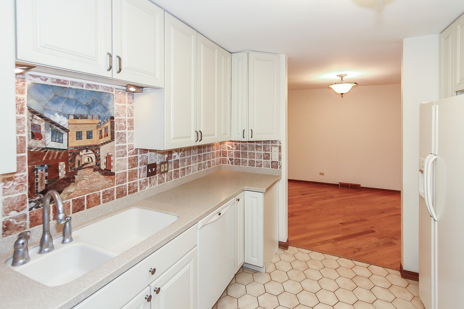 70 South Dee Road, Unit A Park Ridge, IL 60068 - Photo 8 of 20 a kitchen with granite countertop a sink and a stove