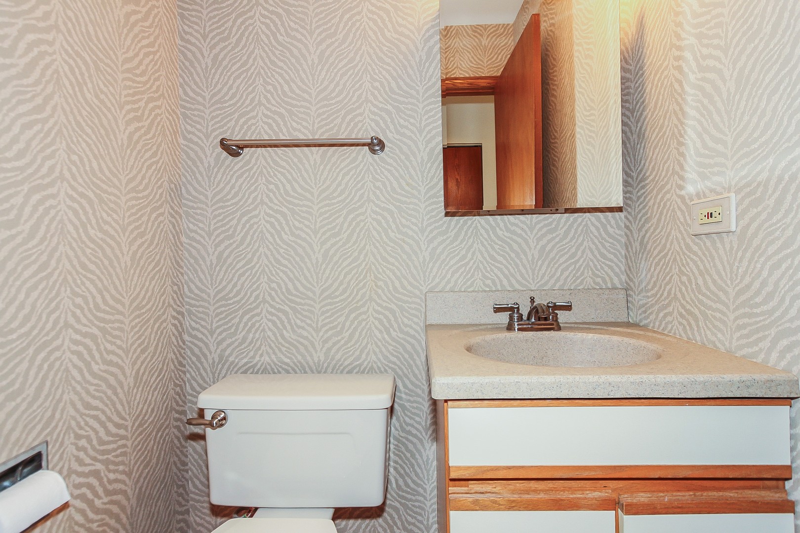 70 South Dee Road, Unit A Park Ridge, IL 60068 - Photo 9 of 20 a bathroom with a sink a toilet and mirror