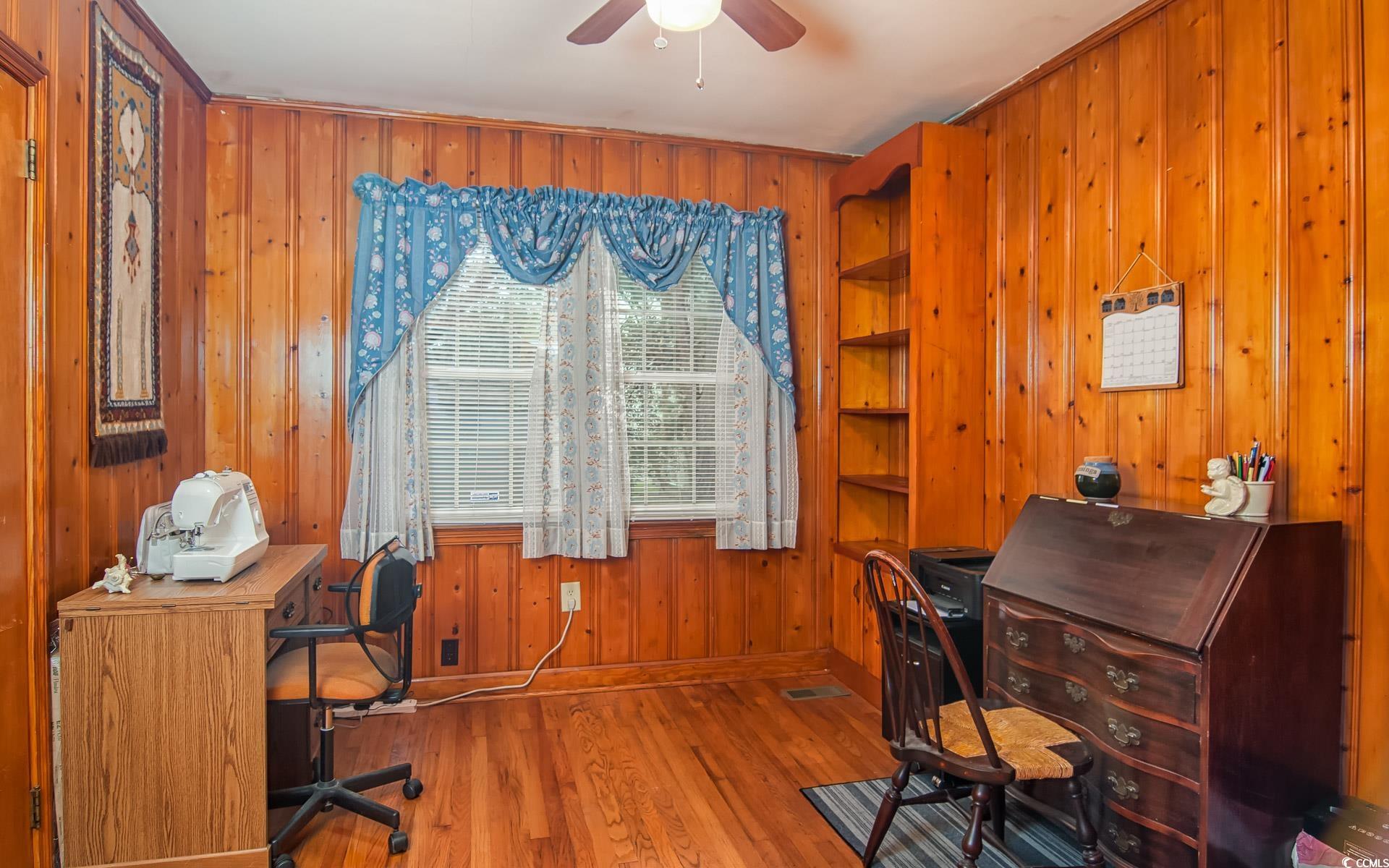 310 St James Street Georgetown, SC 29440 - Photo 13 of 25 Office area with wooden walls, wood finished floors, and a ceiling fan