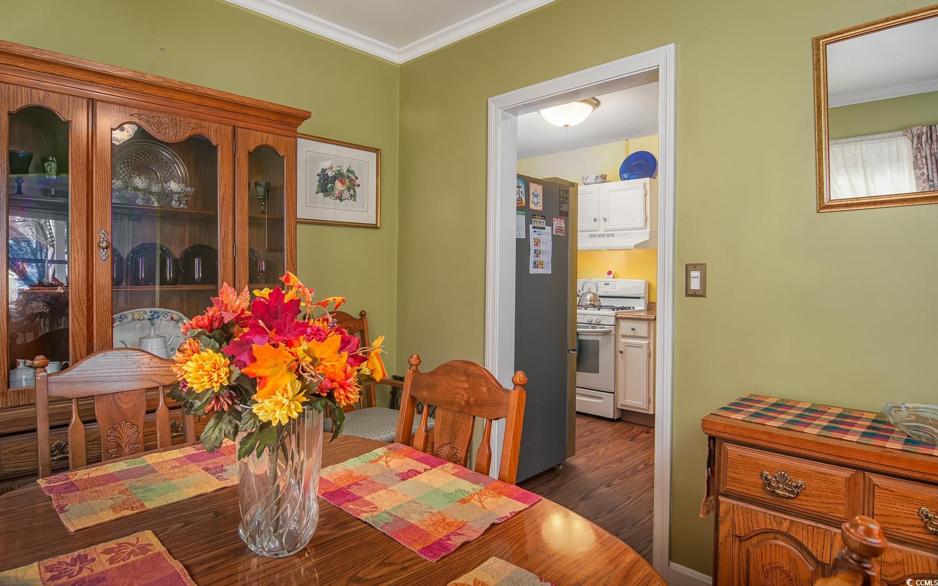 310 St James Street Georgetown, SC 29440 - Photo 7 of 25 Dining area with ornamental molding and dark wood-type flooring