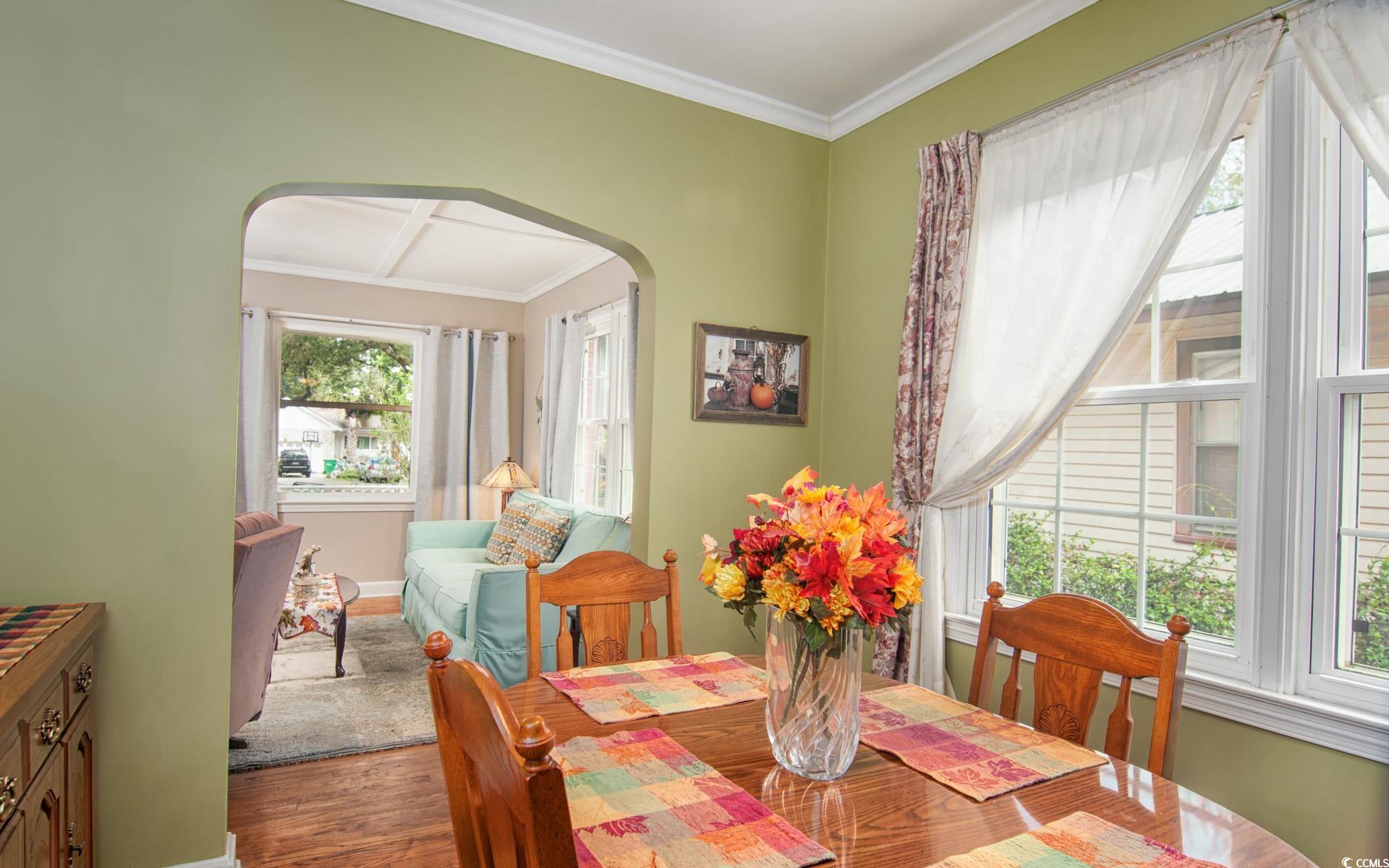 310 St James Street Georgetown, SC 29440 - Photo 8 of 25 Dining space featuring crown molding, dark wood-style floors, and arched walkways