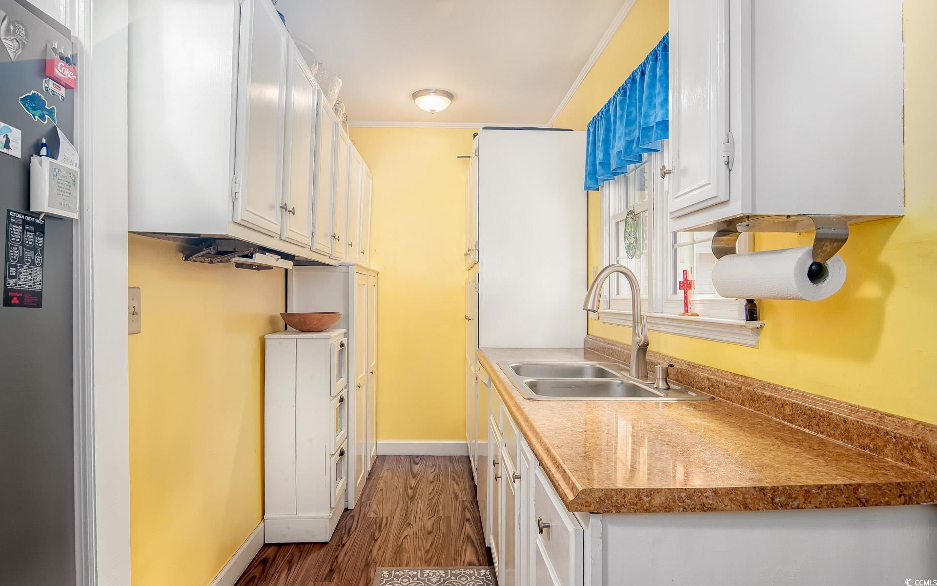 310 St James Street Georgetown, SC 29440 - Photo 9 of 25 Kitchen featuring white cabinets, dark wood finished floors, freestanding refrigerator, and light countertops
