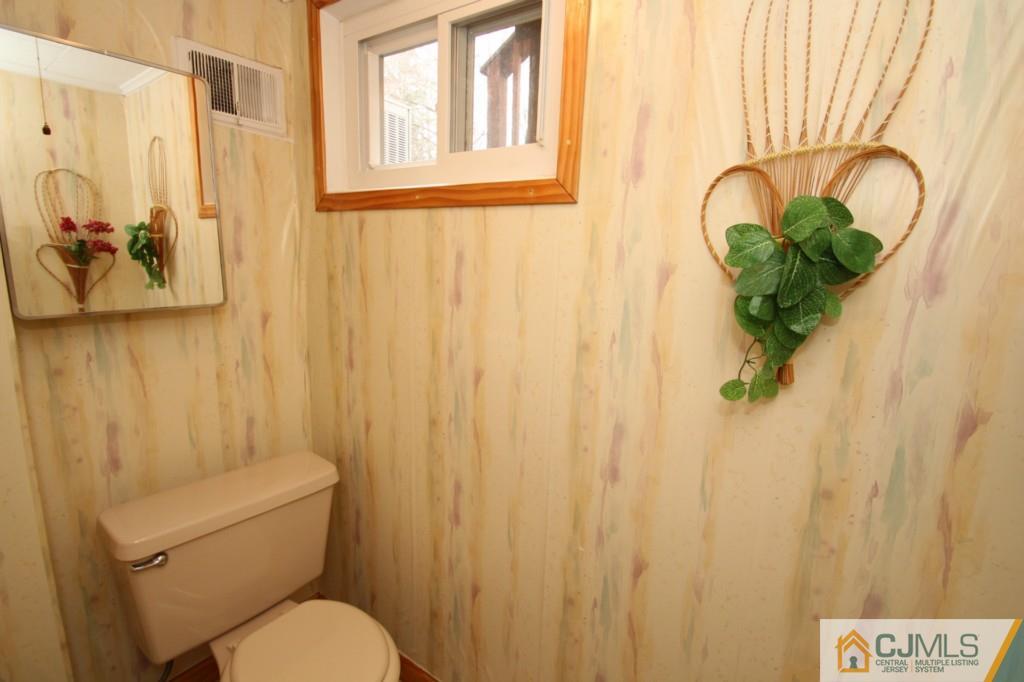 16 Gales Road Edison, NJ 08837 - Photo 23 of 25 a white toilet sitting next to a shower curtain