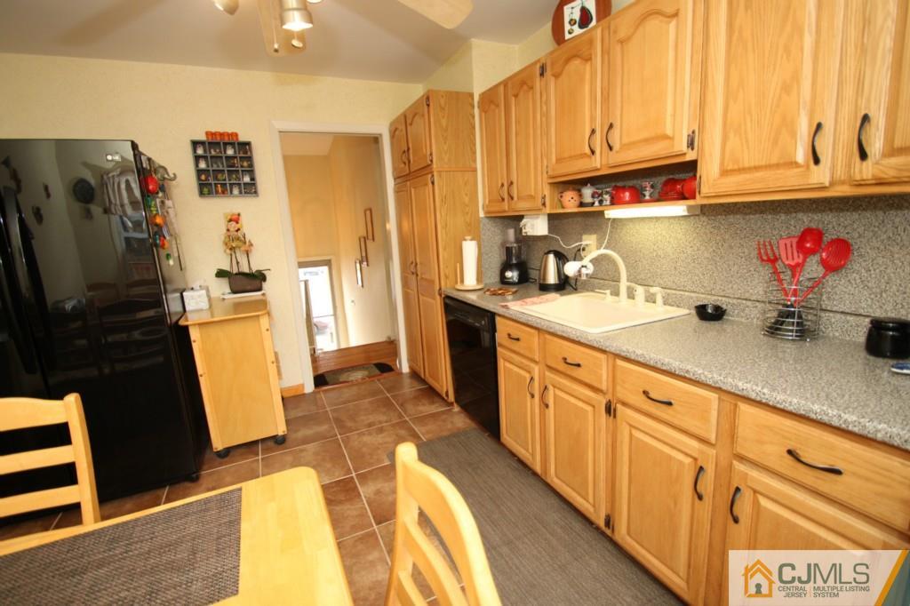 16 Gales Road Edison, NJ 08837 - Photo 10 of 25 a kitchen with stainless steel appliances a sink a refrigerator and cabinets