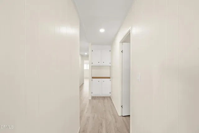 a view of a kitchen with white walls