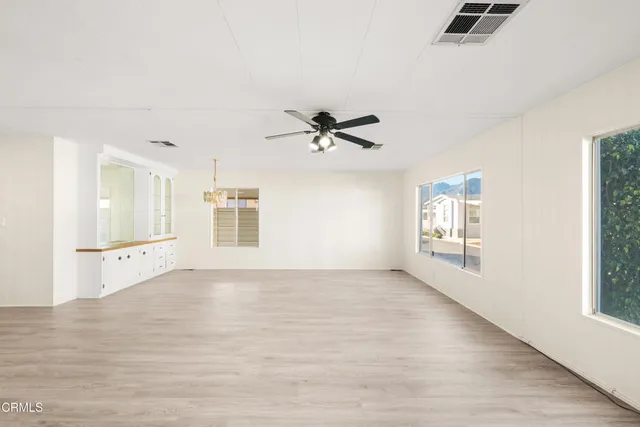 a view of a kitchen with a sink and a refrigerator