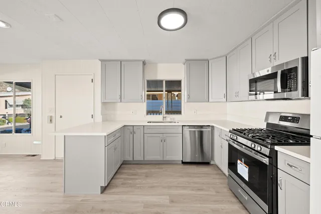 a kitchen with stainless steel appliances granite countertop a stove and a sink
