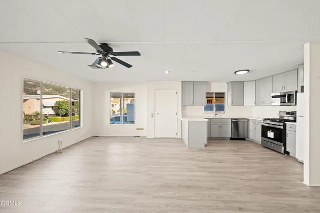 a view of a kitchen with a sink and microwave